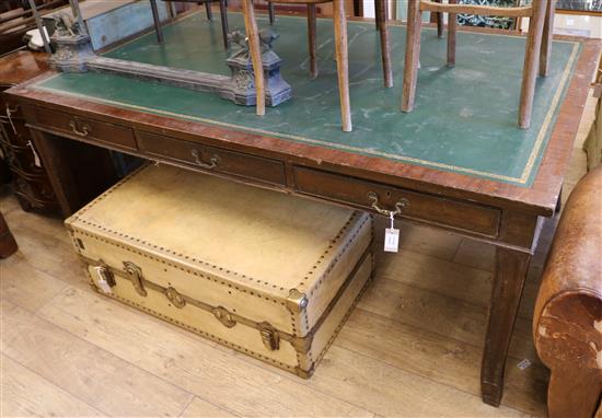 A 1930s green leather topped library table, fitted with three drawers to one side, on square moulded legs W.198cm